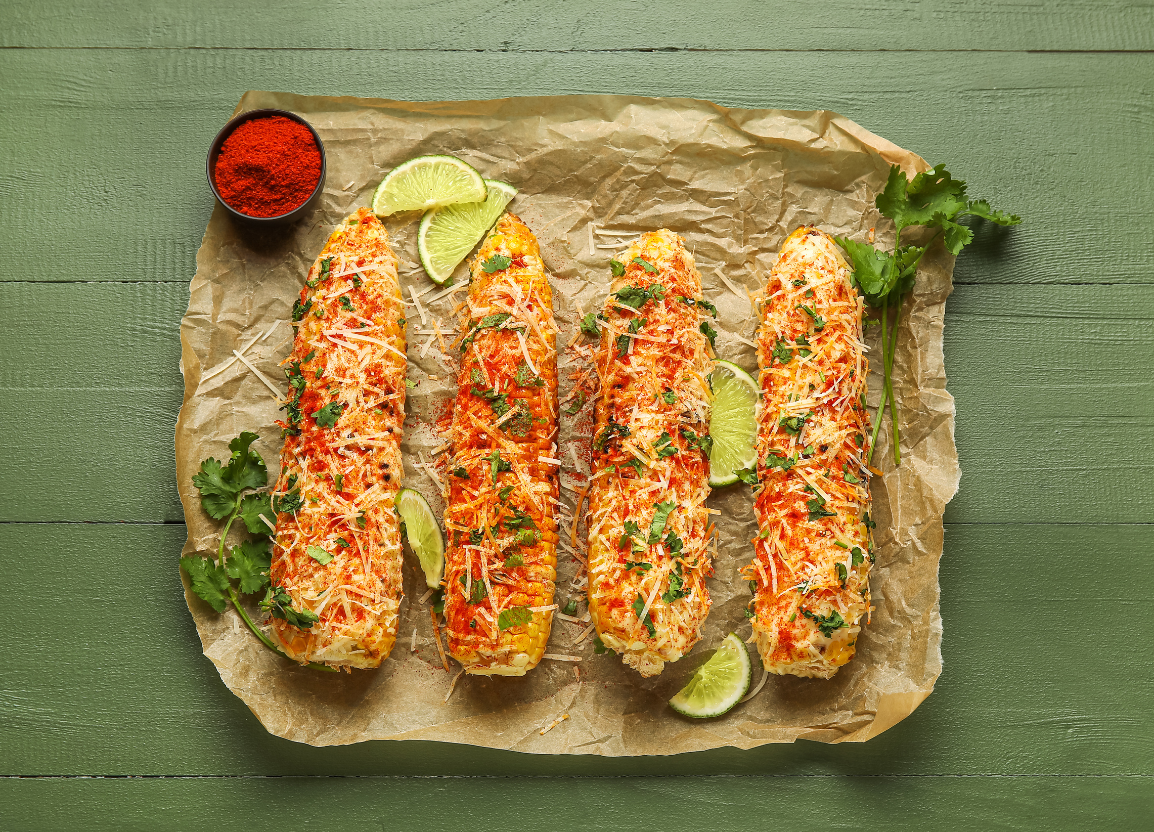 Tasty Elote Mexican Street Corn on Green Wooden Background